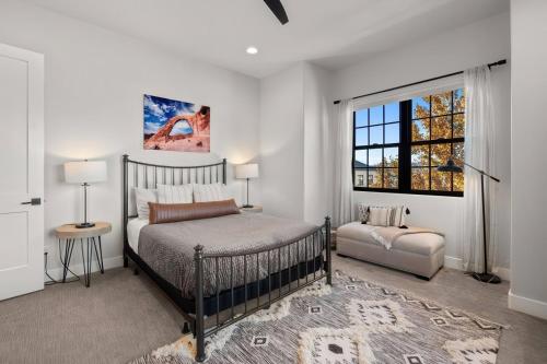a bedroom with a bed and a window at Elim Gem w Pool BBQ Hot Tub N Sand Hollow in Hurricane