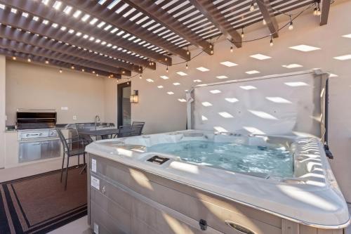 a jacuzzi tub in a room with a kitchen at Elim Gem w Pool BBQ Hot Tub N Sand Hollow in Hurricane