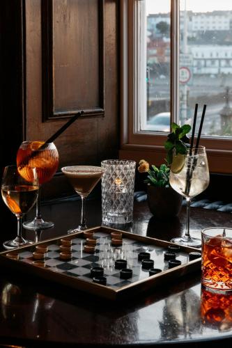 a chess board on a table with glasses on it at The Royal Hotel in Bideford