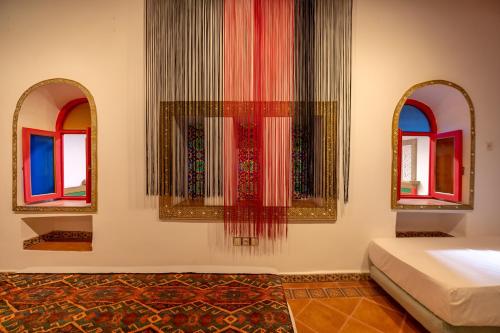 a room with two mirrors and a bed in a room at Riad Amira Luxury Palace in Fès
