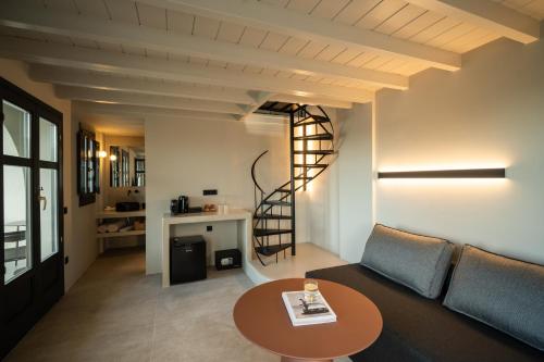 a living room with a couch and a table at Black Diamond Suites in Akrotiri