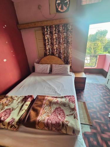 a bedroom with a large bed with a large window at hotel aadarsh in Sendhwa