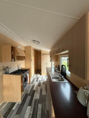 a kitchen with a sink and a counter top at Luxury holiday home cranfield in Lisnacree