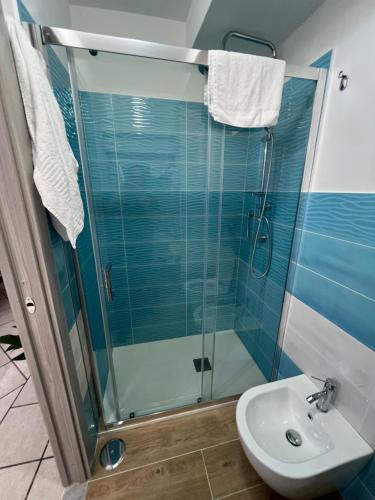 a bathroom with a glass shower and a sink at La casa del postino in Procida
