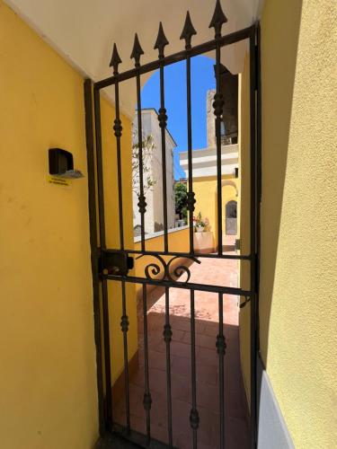 an open gate with a view of a courtyard at La casa del postino in Procida