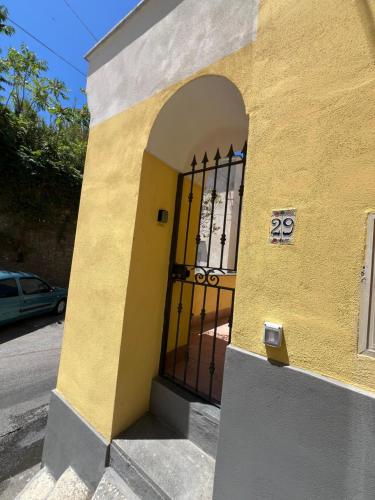 a door to a building with a gate at La casa del postino in Procida