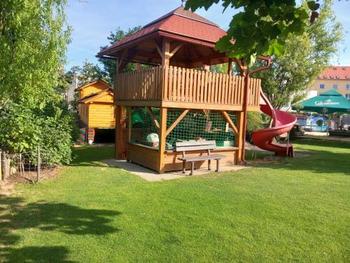 a play structure with a bench and a playground at Penzion Bejby Turnov in Turnov
