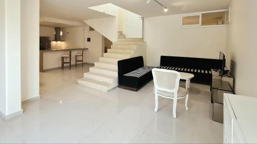 a living room with a couch and a table and chairs at Tabarja Hills apartment in ‘Ayn aş Şughayrah