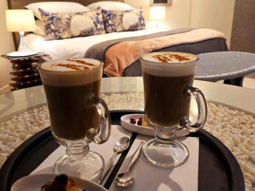 two cups of coffee on a tray on a table at Crystal Lagoon Lodge in Langebaan