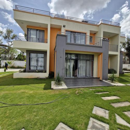 a house with a lawn in front of it at The Royal Hub in Syokimau