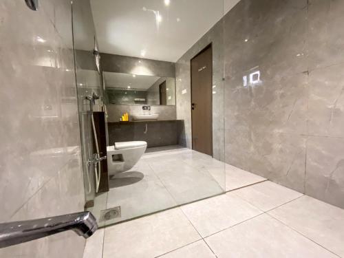 a bathroom with a shower and a sink and a toilet at NULIFE in Jamnagar