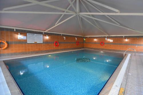 a large swimming pool in a building at Emirates Stars Hotel Apartments Dubai in Dubai