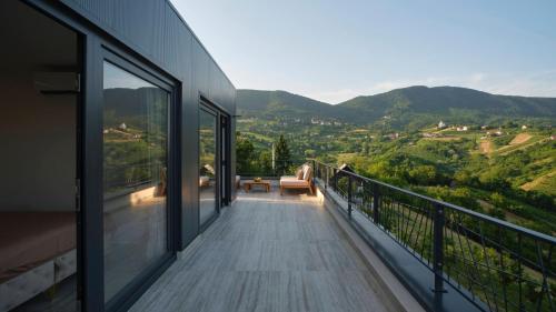 a balcony of a house with a view of the mountains at Villa Terra in Plešivica