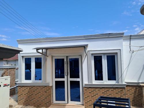 a white house with french doors on it at House 13 Parmor estate in Mama