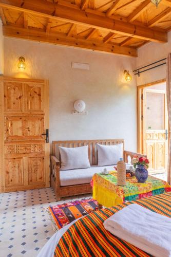a bedroom with two beds and a couch at Riad Berber Towers in Imlil