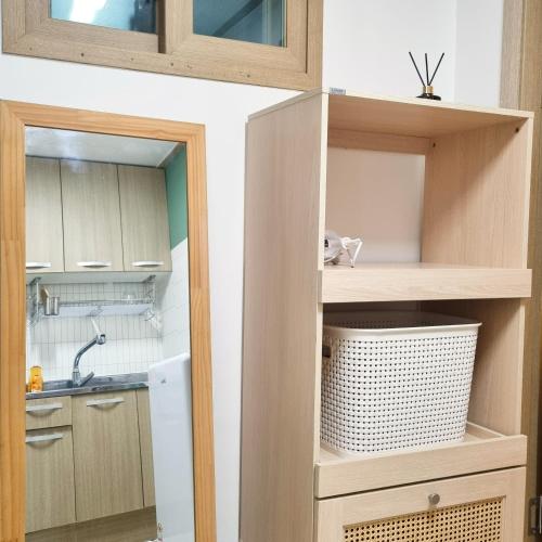 a kitchen with wooden cabinets and a sink at Forest Sillim - private room in Seoul