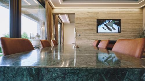 a conference room with a large marble table and chairs at Villa Terra in Plešivica