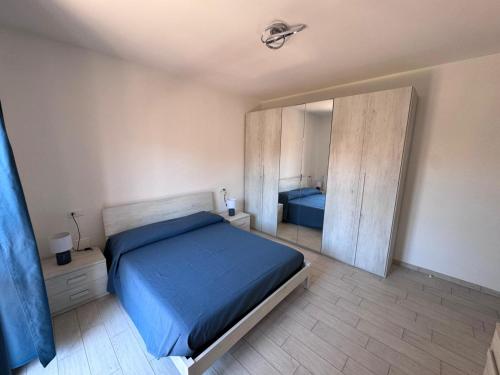 a bedroom with a blue bed and a mirror at Al' Rrigo in Bolsena