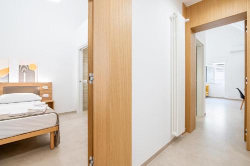 a bedroom with a bed and a door leading into a room at Casa Agata in Leverano