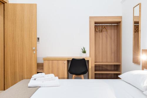 a bedroom with a bed and a desk and a chair at Casa Agata in Leverano