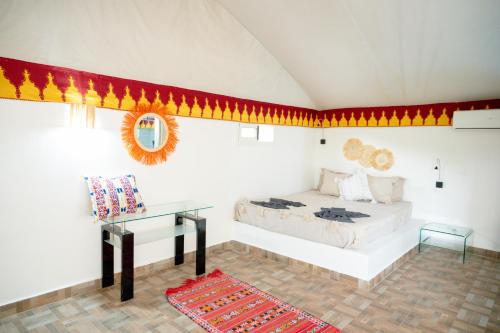 a room with a bed and a table in a room at Oléa villa & lodge in Marrakesh
