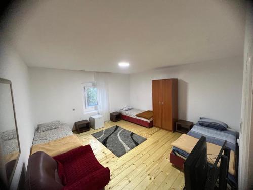 a bedroom with two beds and a couch in it at Mountain House Komovi in Kravlja