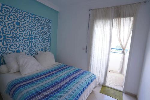 Ένα ή περισσότερα κρεβάτια σε δωμάτιο στο Apartment in Ryad Sofia Martil 2 bedrooms all comforts