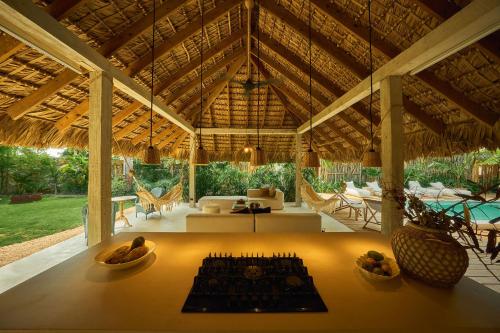 a large pavilion with a table and chairs and a couch at Buena Vida Macao 7 habitaciones in Salado