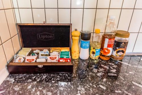 a kitchen counter with a box of food and alcohol at Simple and Rustic - Apartment in Historic House in Wilderswil
