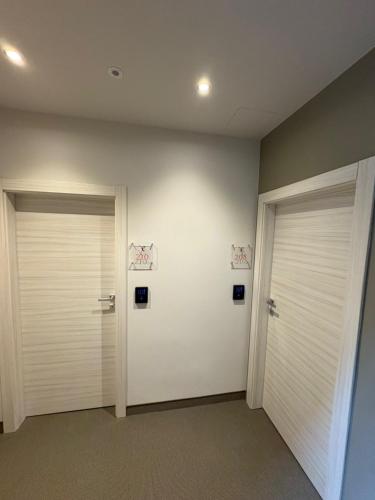 two white doors in a room withermottermottermottermott at Villa Ersilia in Limone sul Garda