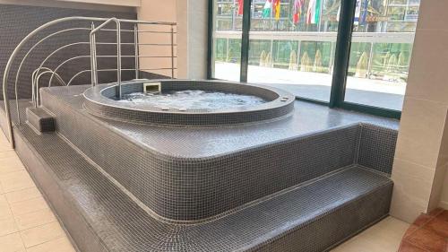 a large metal tub in a building with a window at Hotel Marvel All Inclusive - FULLY RENOVATED FREE Beach Access in Sunny Beach