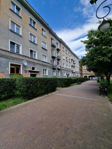 a brick sidewalk in front of a large building at Apartament Arkadowa in Tychy