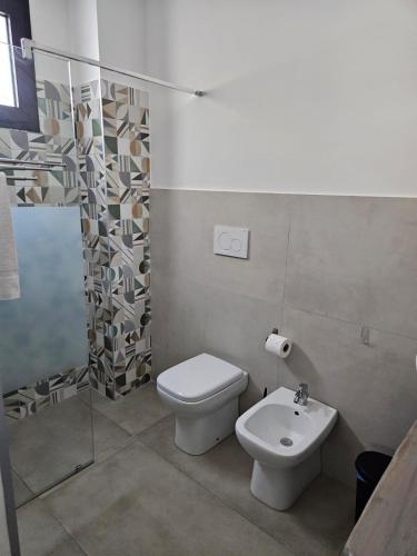 a bathroom with a toilet and a sink at B&b Anna Leverano in Leverano