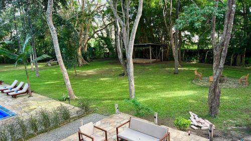 an aerial view of a garden with chairs and a pool at Green Hills Lodge in Usa River