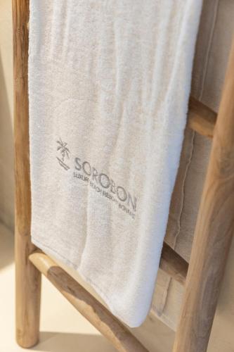 a towel on the back of a wooden chair at Sorobon Bay Hotel in Kralendijk