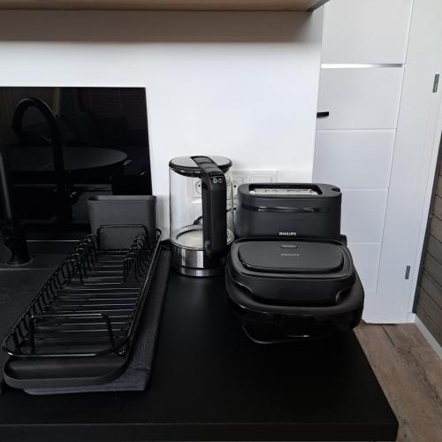 a black counter top with a stove top oven at Domki Wilków z widokiem na Łysicę in Wilków