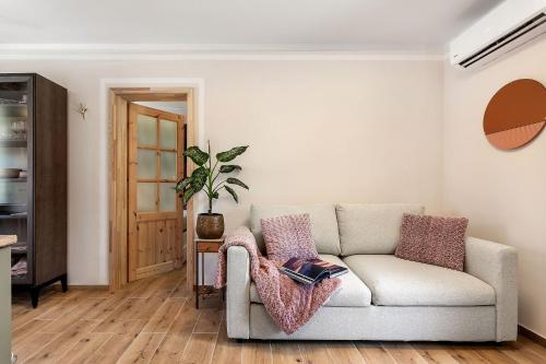 a living room with a couch and a plant at Garden House 202 by Sigismundi in Brežice