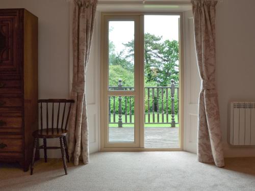 an open door in a room with a chair at Bodwen in Wootton Bridge