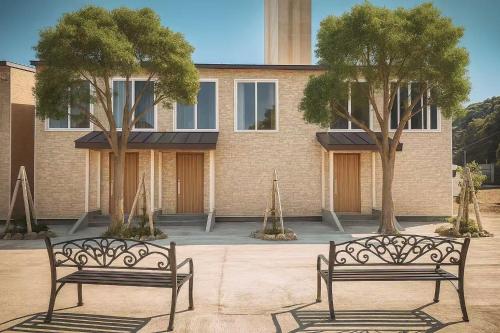 two benches sitting in front of a building at GraceNiseko in Niseko