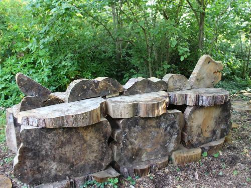 a bench made out of logs and rocks at Bodwen in Wootton Bridge