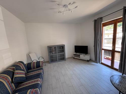 a living room with a couch and a tv at Al' Rrigo in Bolsena