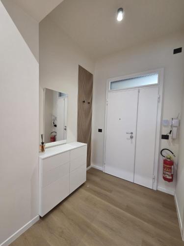 a white bathroom with a sink and a mirror at Nakupenda B&B in Cosenza