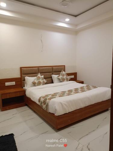 a bedroom with a large bed in a room at Hotel VOLGA INN in Ahmedabad