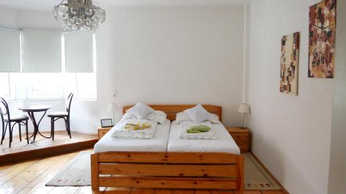 a bedroom with a bed and a table and chairs at Lerchenhof in Friesach