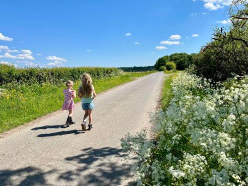 two little girls walking down a road at La ferme du Ravet - Gîtes aux Lacs de l'Eau d'Heure in Froid-Chapelle