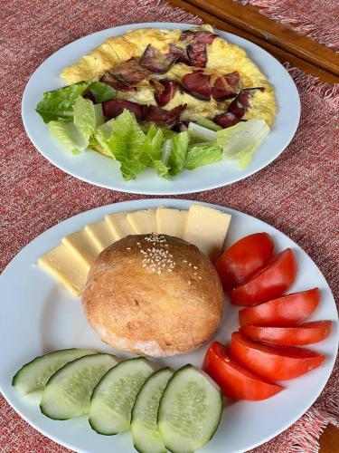 two plates of food with cheese and vegetables on them at Port Ayas Resort & Restaurants in Sevan