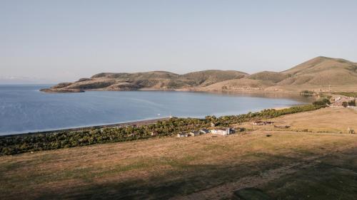 an aerial view of a lake with mountains in the background at Port Ayas Resort & Restaurants in Sevan