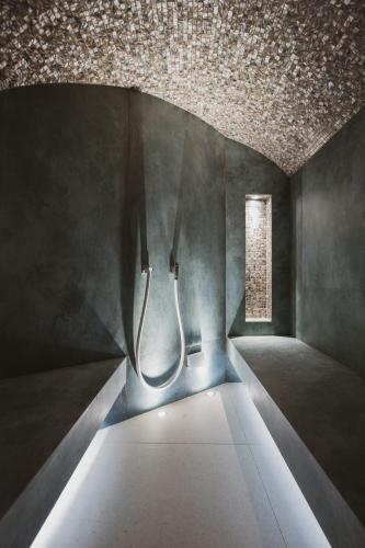 a dark room with a ceiling and a window at Hôtel Cala di Greco in Bonifacio