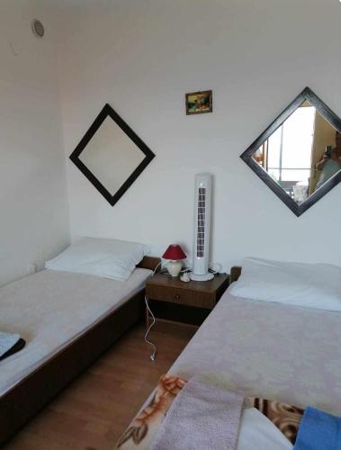 a bedroom with two beds and a window at Kapiton 2 in Jelsa