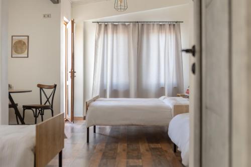 a bedroom with two beds and a table and a window at Port Ayas Resort & Restaurants in Sevan
